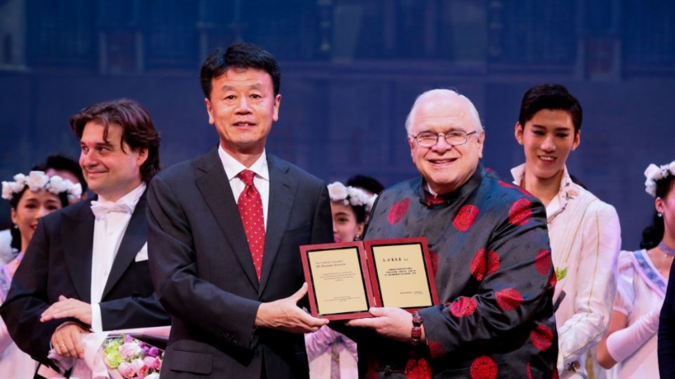 Ben Stevenson, O.B.E. receiving an award onstage after a performance of the National Ballet of China.