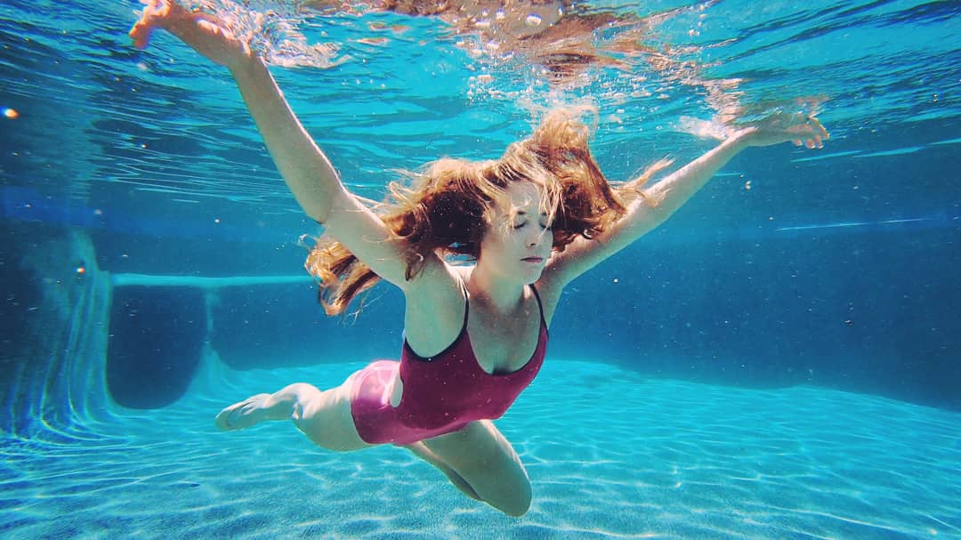 Female dancer underwater in a swimming pool